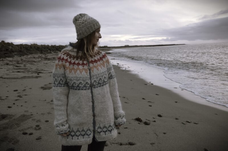 Wool sweater on beach in Gardur, Iceland